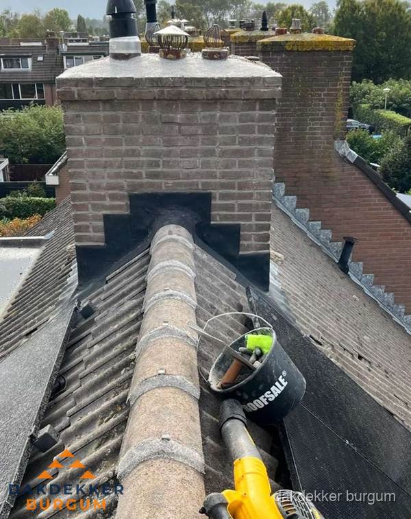 Schoorsteen met loodaansluiting en nokvorst op pannendak in Burgum Schoorsteen met loodaansluiting en nokvorst op pannendak in Burgum